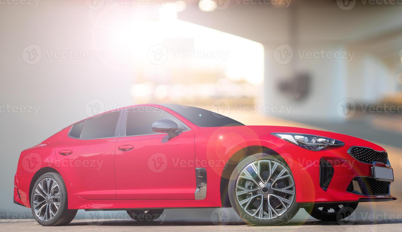 A red car on a background of city environment. Stylish, modern, bright image of the car for design solutions. photo