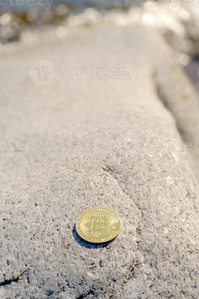 Golden bitcoin coin in natural stones. New financial system. photo