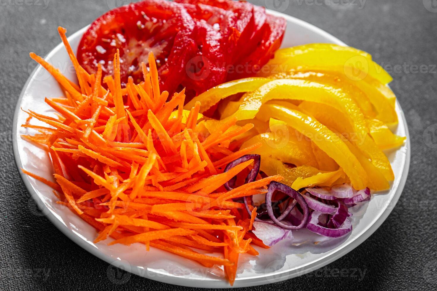 salad fresh vegetables cut into a plate tomato, carrot, pepper, onion juicy fresh gourmet food background on the table rustic food top view copy space keto and paleo diet Vegetarian and vegan photo