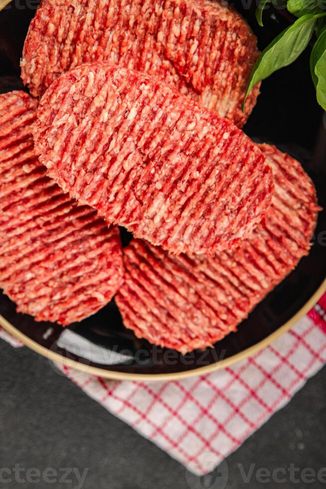 Raw cutlet fresh ground meat beef burger, pork, chicken, turkey second course dish fresh delicious gourmet food background on the table rustic food top view copy space photo