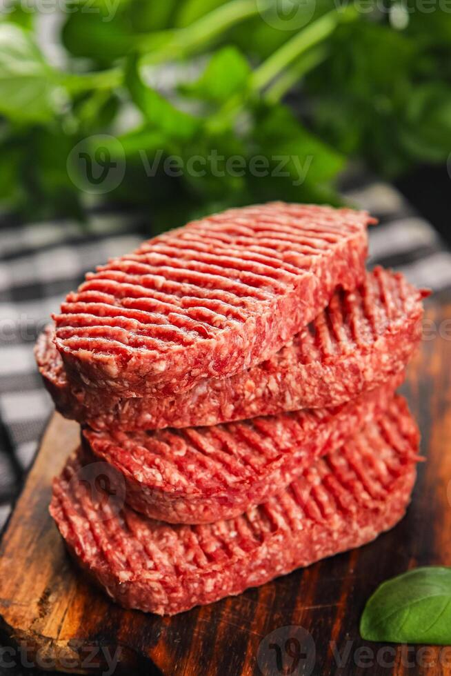 Raw cutlet fresh ground meat beef burger, pork, chicken, turkey second course dish fresh delicious gourmet food background on the table rustic food top view copy space photo
