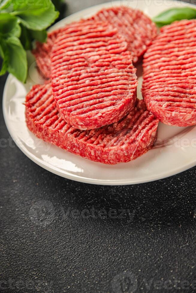 Raw cutlet fresh ground meat beef burger, pork, chicken, turkey second course dish fresh delicious gourmet food background on the table rustic food top view copy space photo