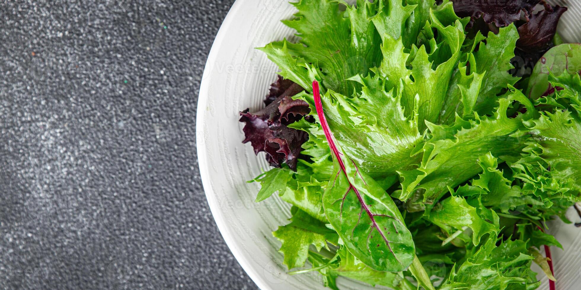 green salad leaves mix salad fresh meal food snack on the table copy space food background rustic photo