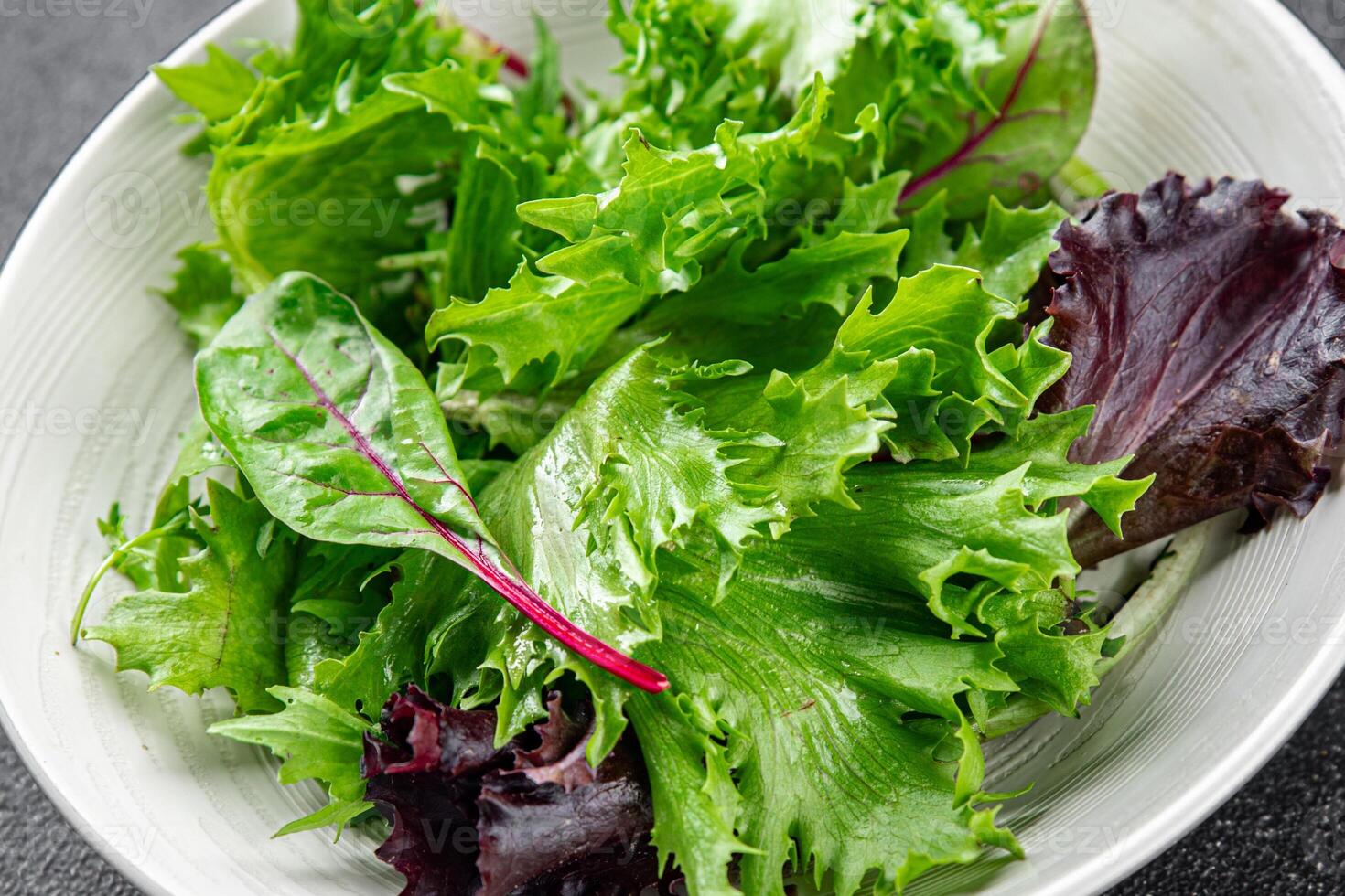 green salad leaves mix salad fresh meal food snack on the table copy space food background rustic photo