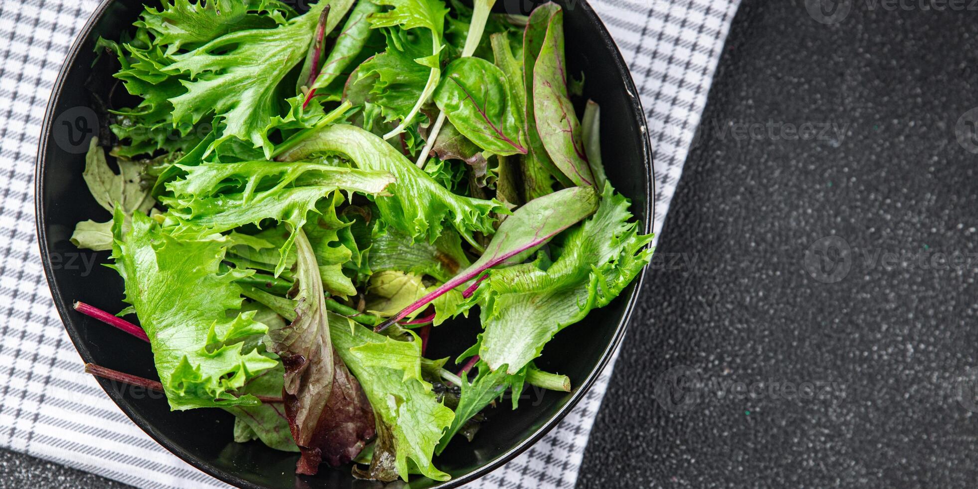 green salad leaves mix salad fresh meal food snack on the table copy space food background rustic photo