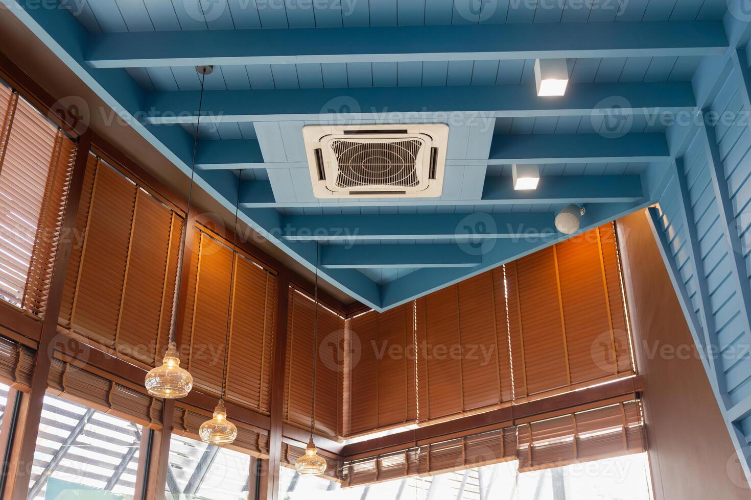Modern ceiling mounted cassette type air conditioning system in coffee shop photo
