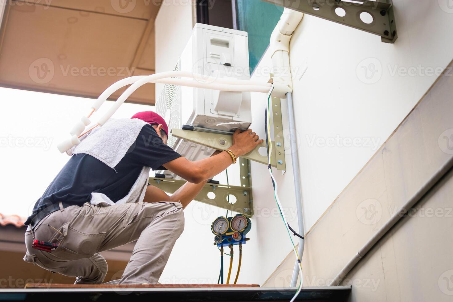 Repairman service for repair and maintenance of air conditioners, Technician man install new air conditioner photo