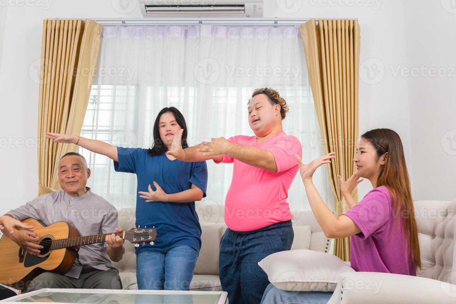 Senior man and grandchild having fun together while singing and playing the guitar in living room at home photo