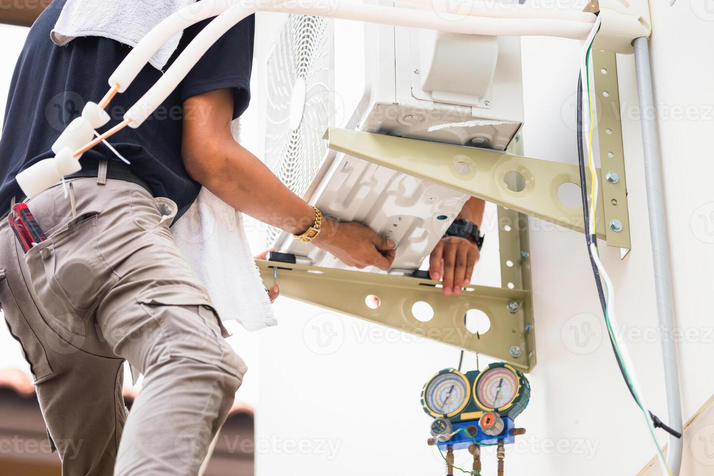 Repairman service team for repair and maintenance of air conditioners, Technician man install new air conditioner photo