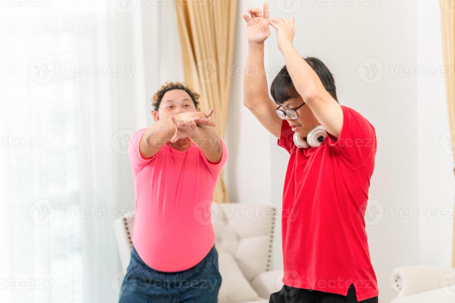 Funny friends dancing and singing at home, Two cheerful young Asian man dance in living room photo