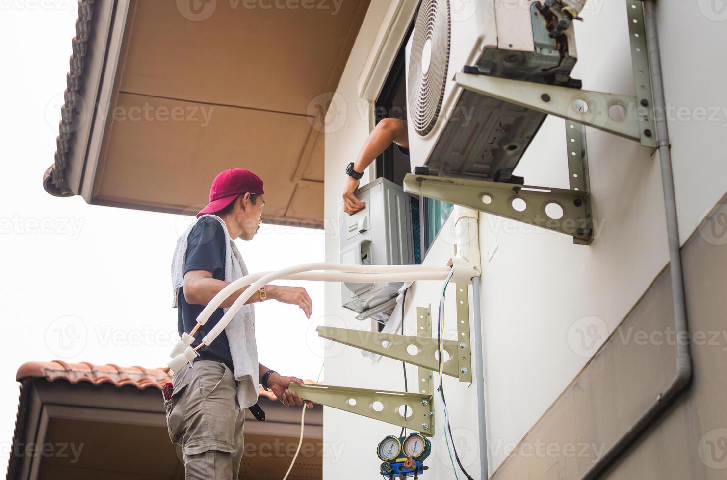 Repairman service team for repair and maintenance of air conditioners, Technician man install new air conditioner photo