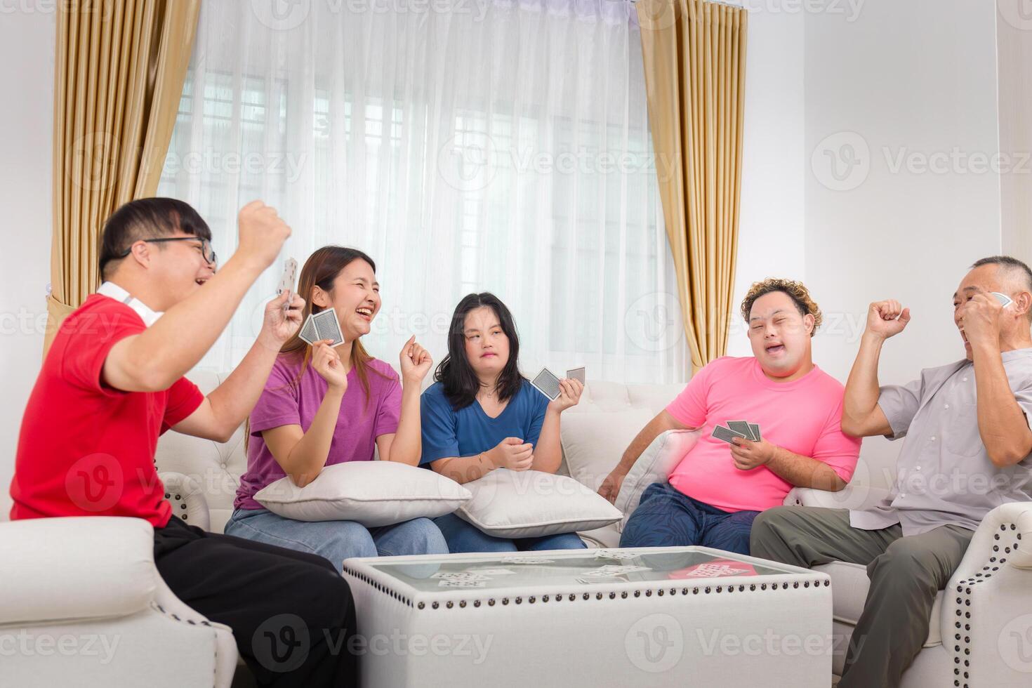 Asian family, Grandchild interacting with friends and playing cards with grandparents at home photo