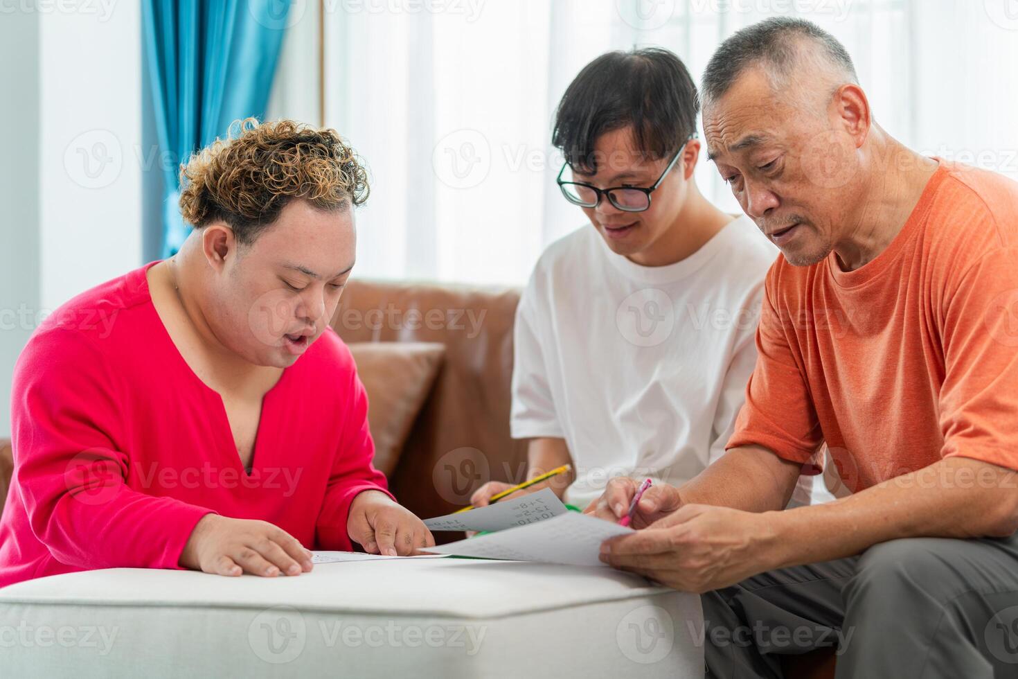 Senior man and grandchild practice math skill, interactive math game, Grandfather supervising grandchild sitting at sofa doing homework photo