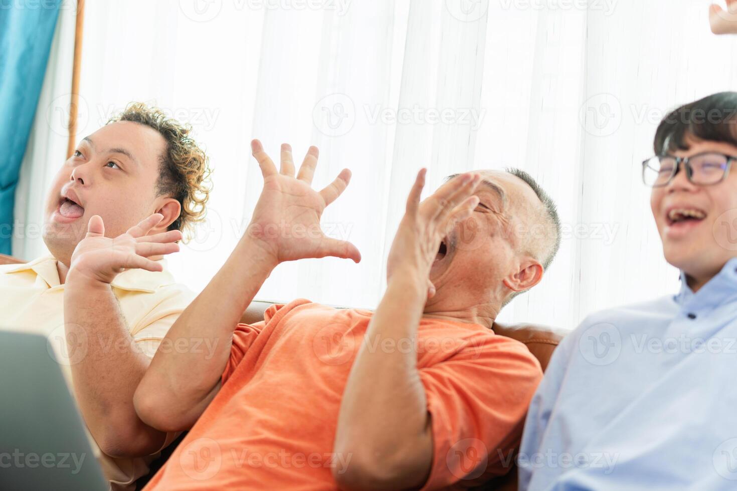 Senior asian man having a good time sitting on couch at home with adult son, Cheerful grandfather and grandson in living room photo