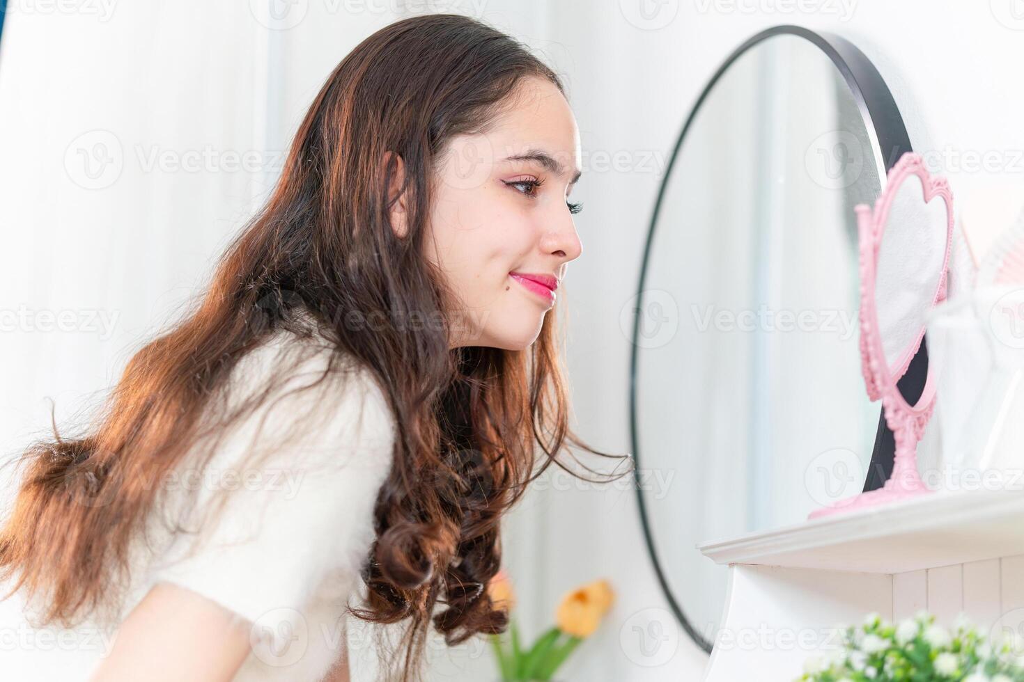 Smiling of cheerful beautiful pretty teenage girl felling relaxing and enjoy makeup time at dressing tables photo