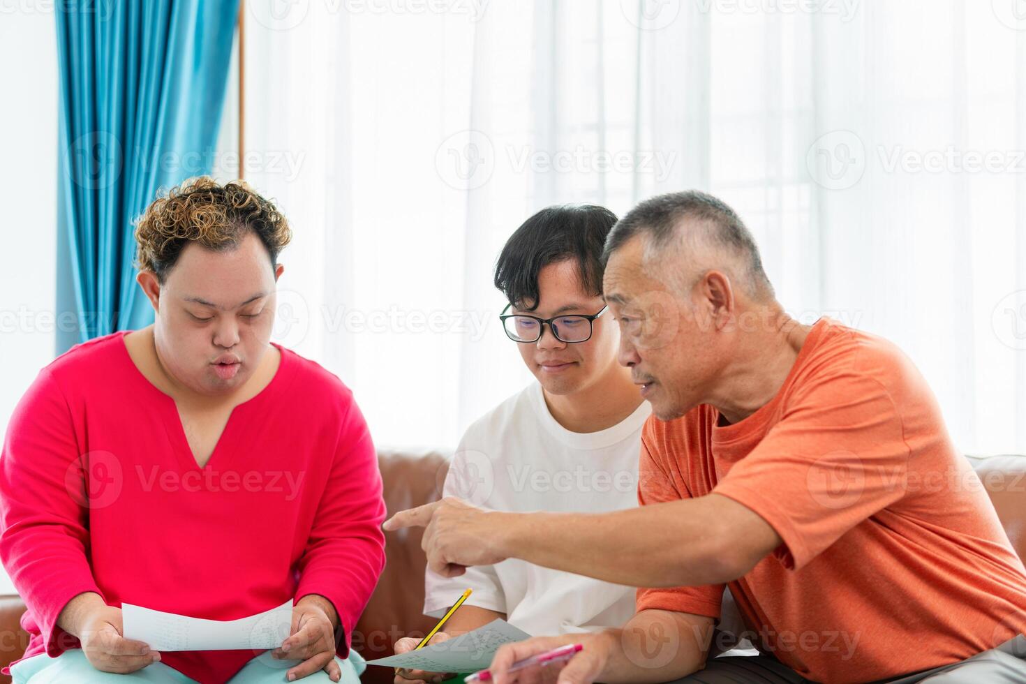 Asian Senior man relaxing with grandchild, Senior man and grandchild practice math skill, interactive math game, Grandfather supervising grandchild sitting at sofa doing homework photo