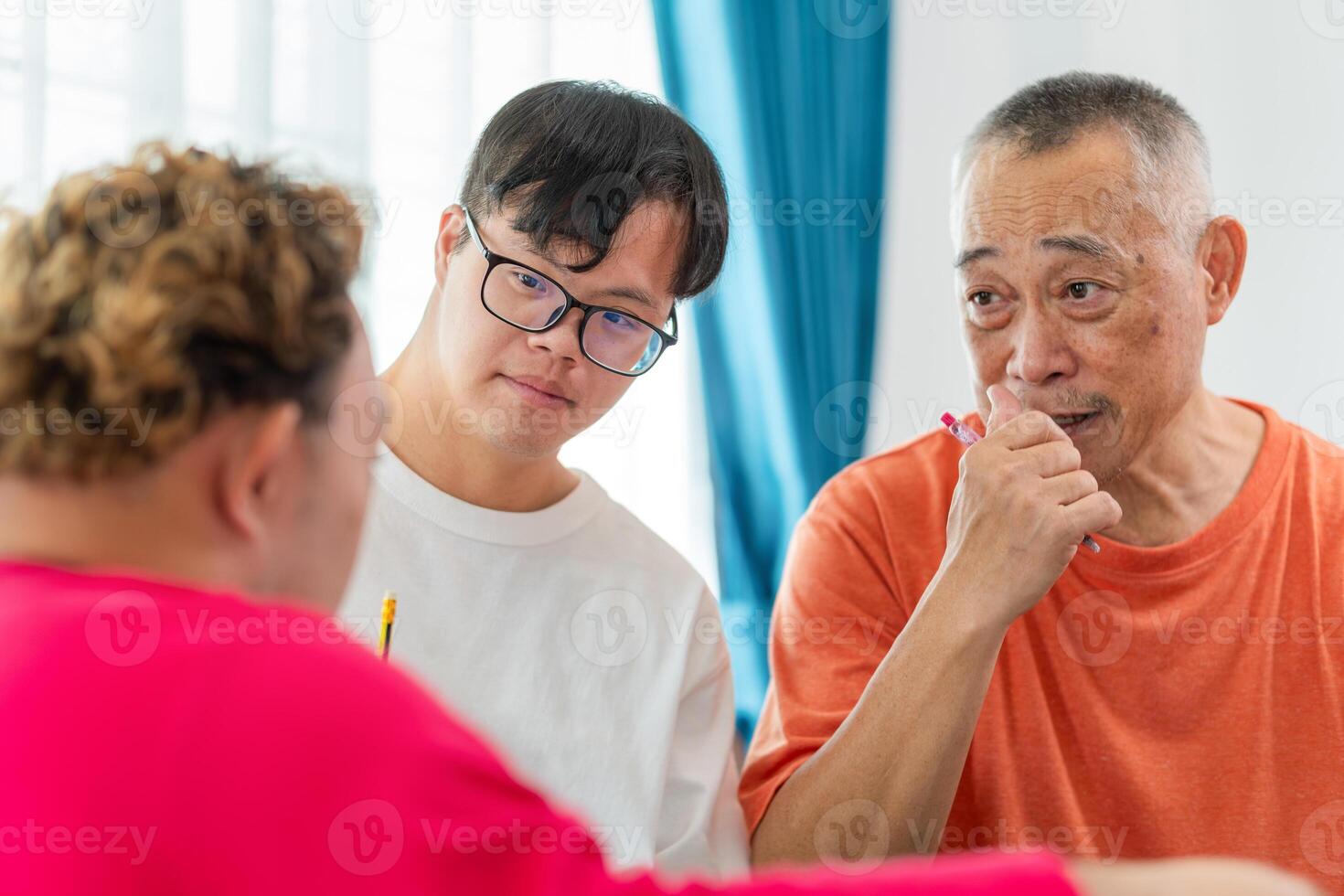 Senior man and grandchild practice math skill, interactive math game, Grandfather supervising grandchild sitting at sofa doing homework photo