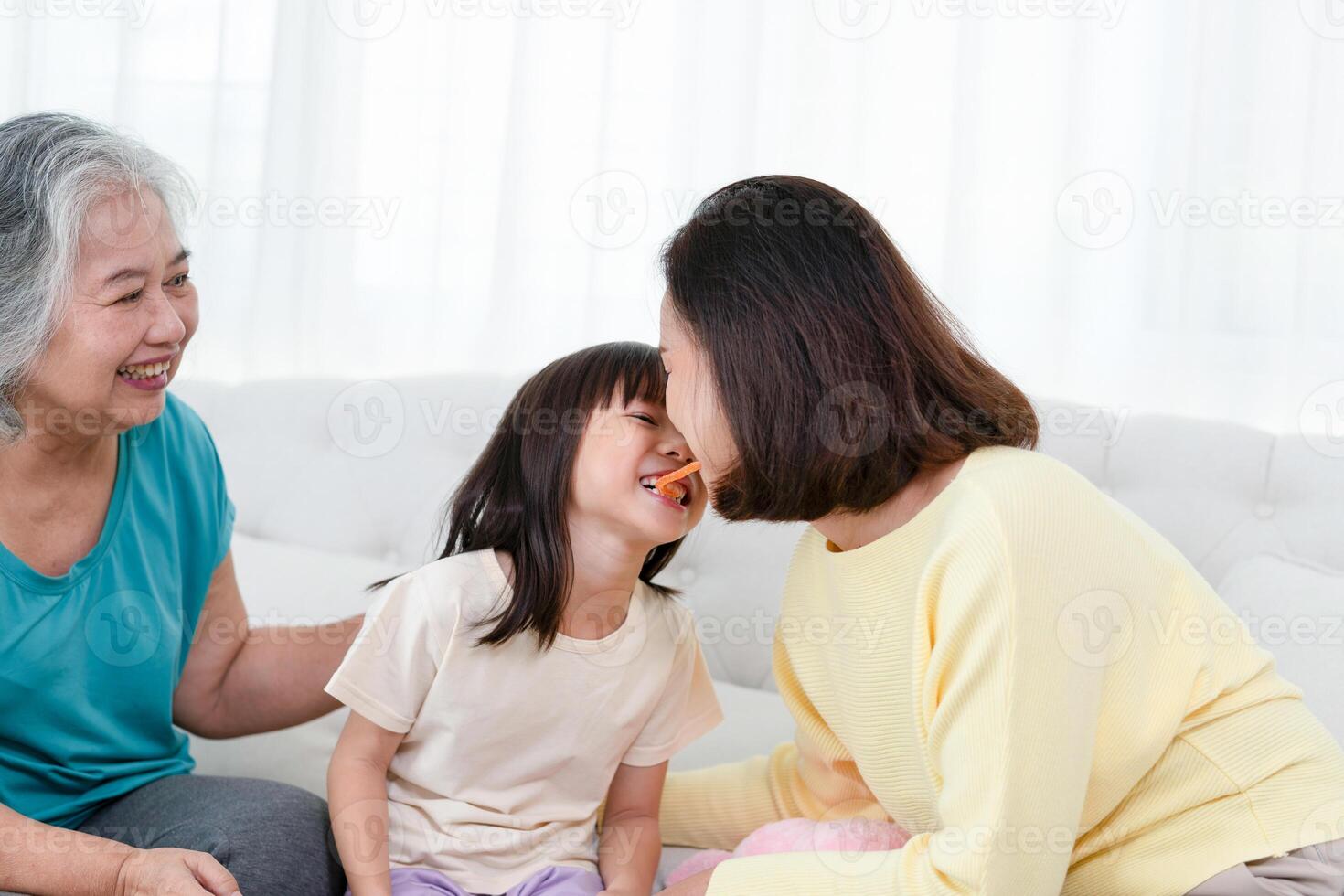 Asian mother and daughter enjoying in living room, Grandparents enjoying with grandchild in living room at home photo
