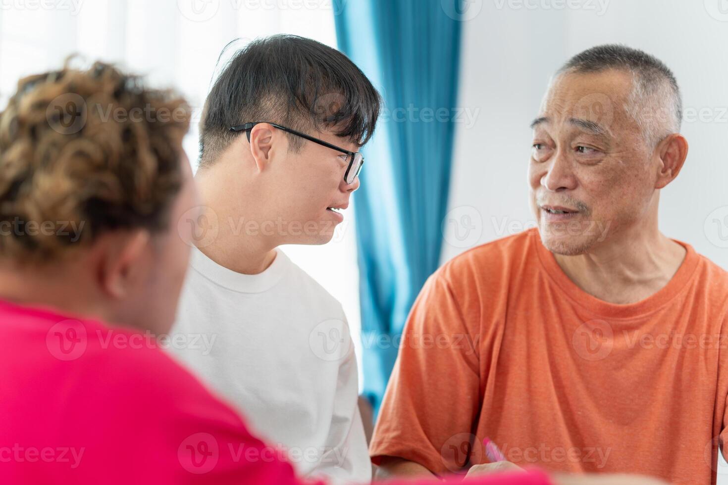 Senior man and grandchild practice math skill, interactive math game, Grandfather supervising grandchild sitting at sofa doing homework photo