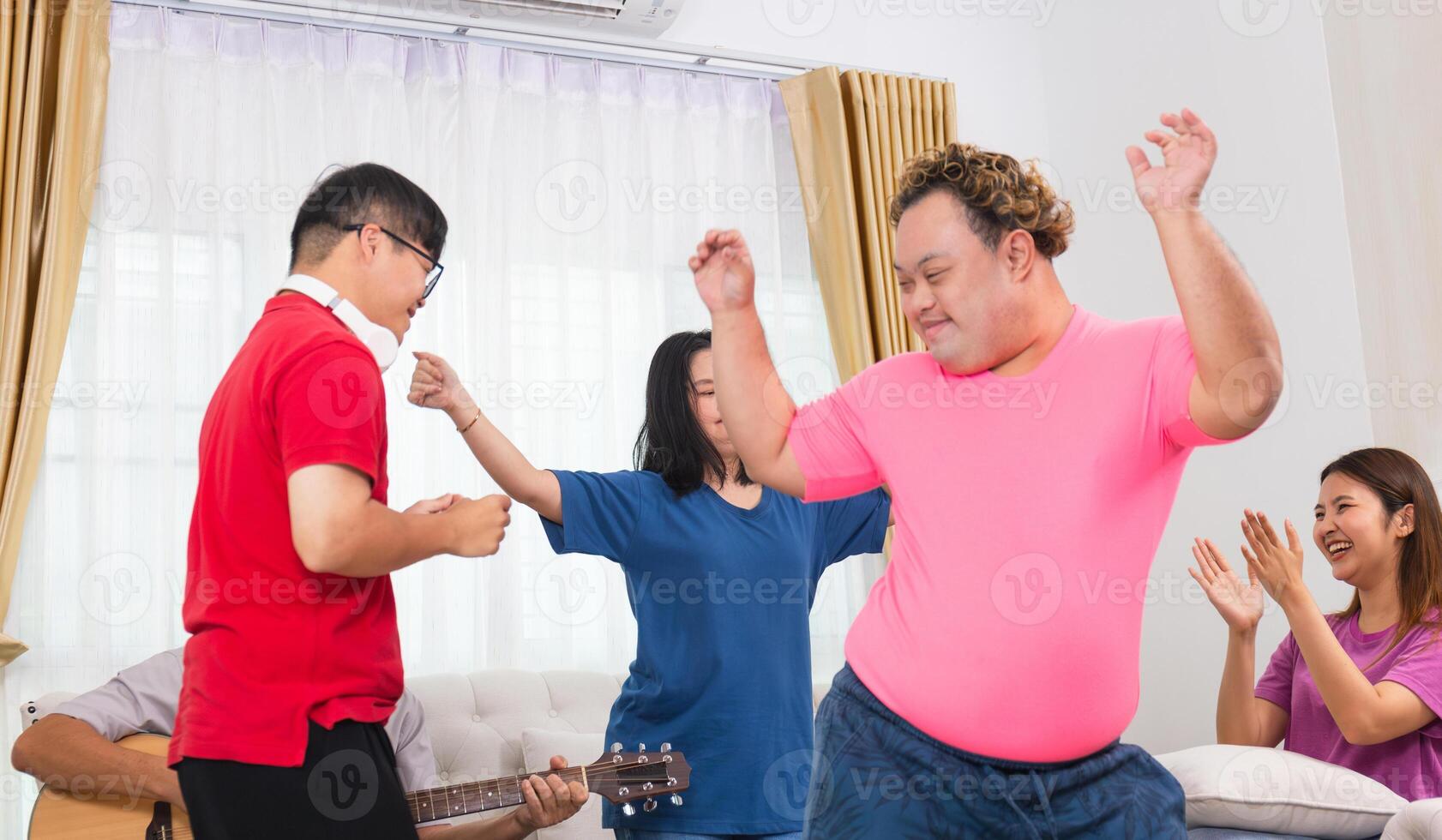 Senior man and grandchild having fun together while singing and playing the guitar in living room at home photo