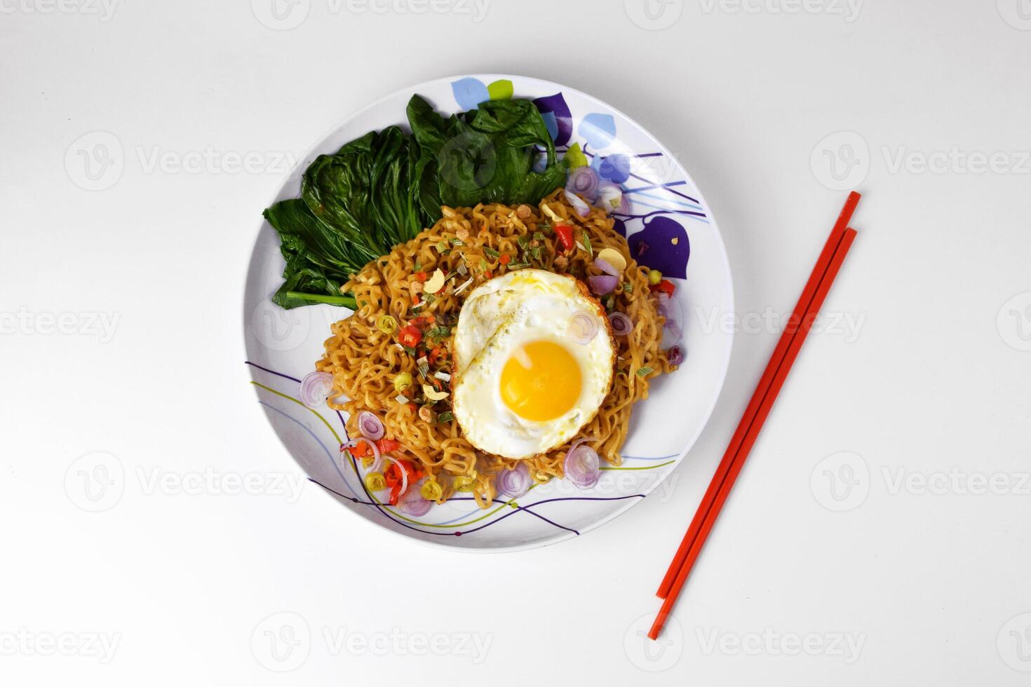 Closeup photo of Fried noodles with sunny side up egg on a plate