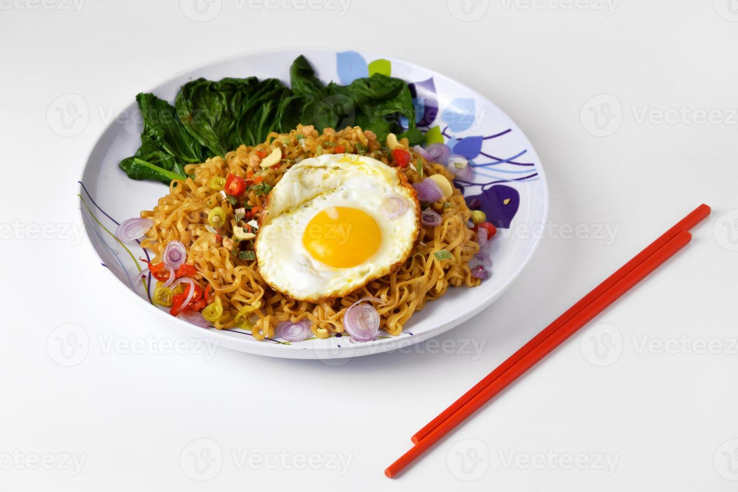 Closeup photo of Fried noodles with sunny side up egg on a plate