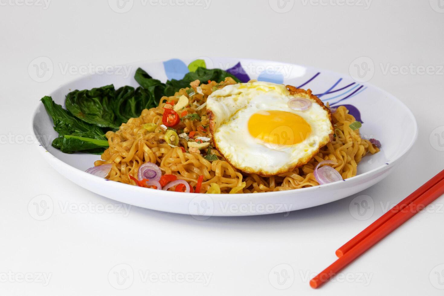 Closeup photo of Fried noodles with sunny side up egg on a plate