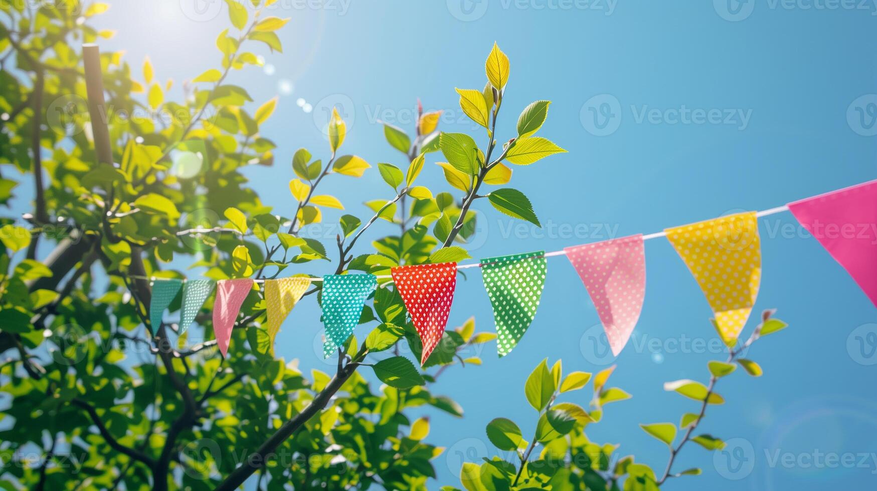 Captivating Colorful Pennant String Adorning Verdant Green Tree Foliage photo