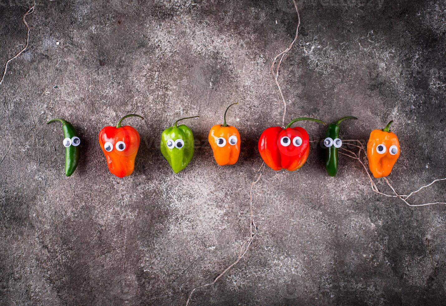 Cute color bell pepper with eyes. photo