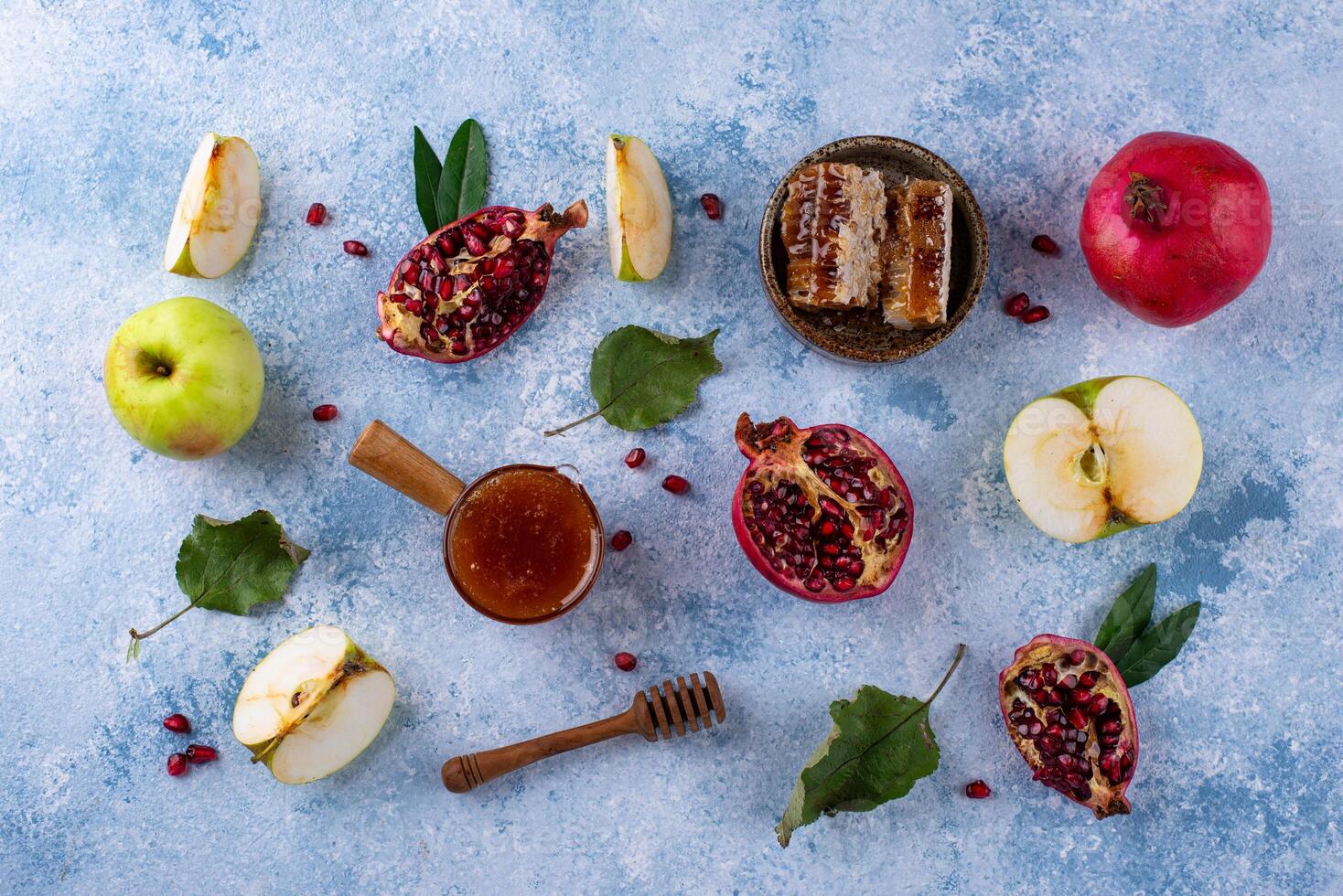 Rosh Hashana concept with honey, apple and pomegranate photo