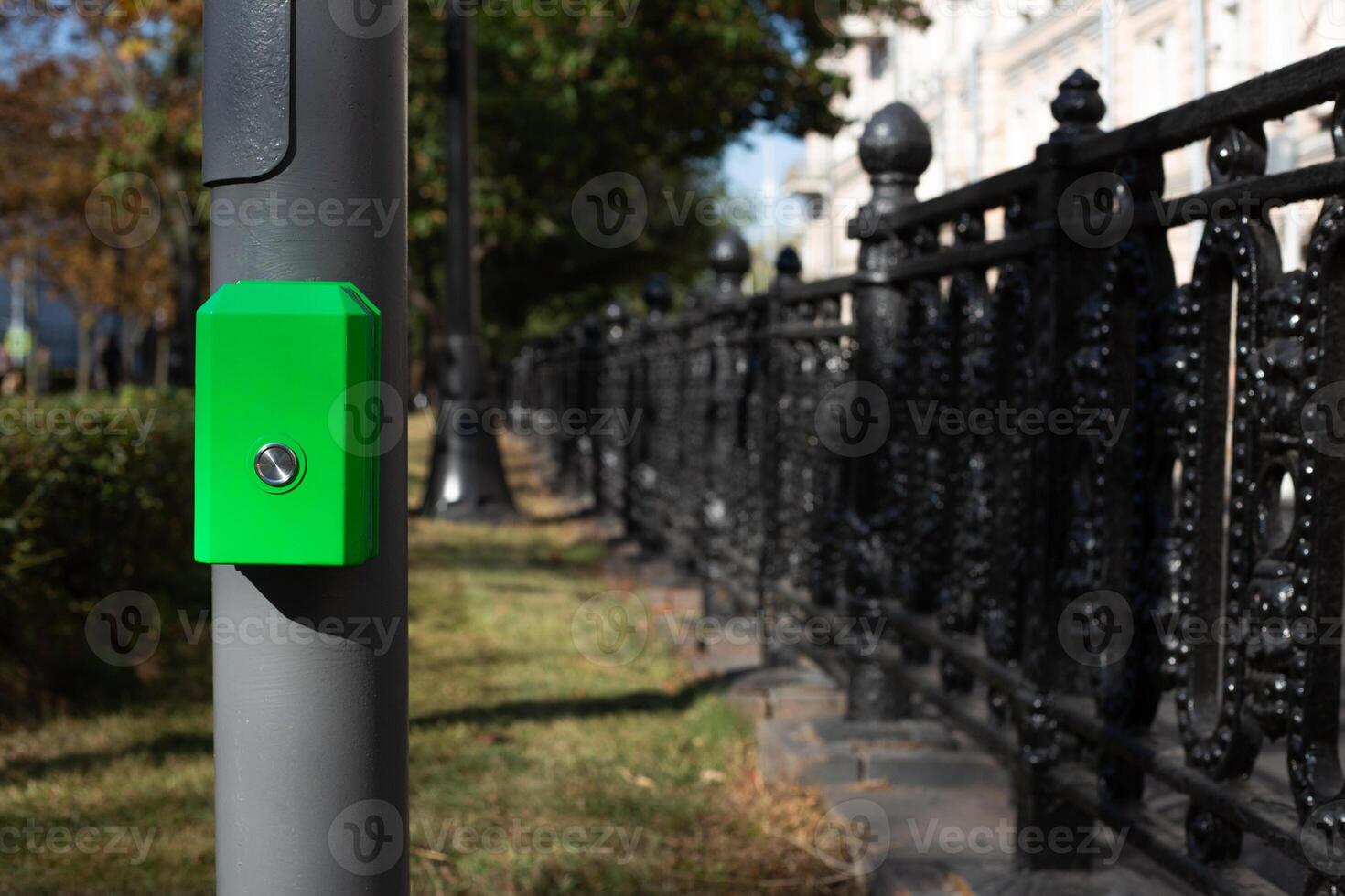 Button for changing the traffic light mode at pedestrian crossing. Button for pedestrians on pole to change traffic light signal to cross the road photo