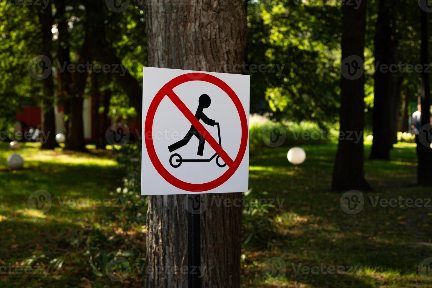 Scooter symbol in park prohibiting riding on public street in city. Illegal movement on an electric scooter photo