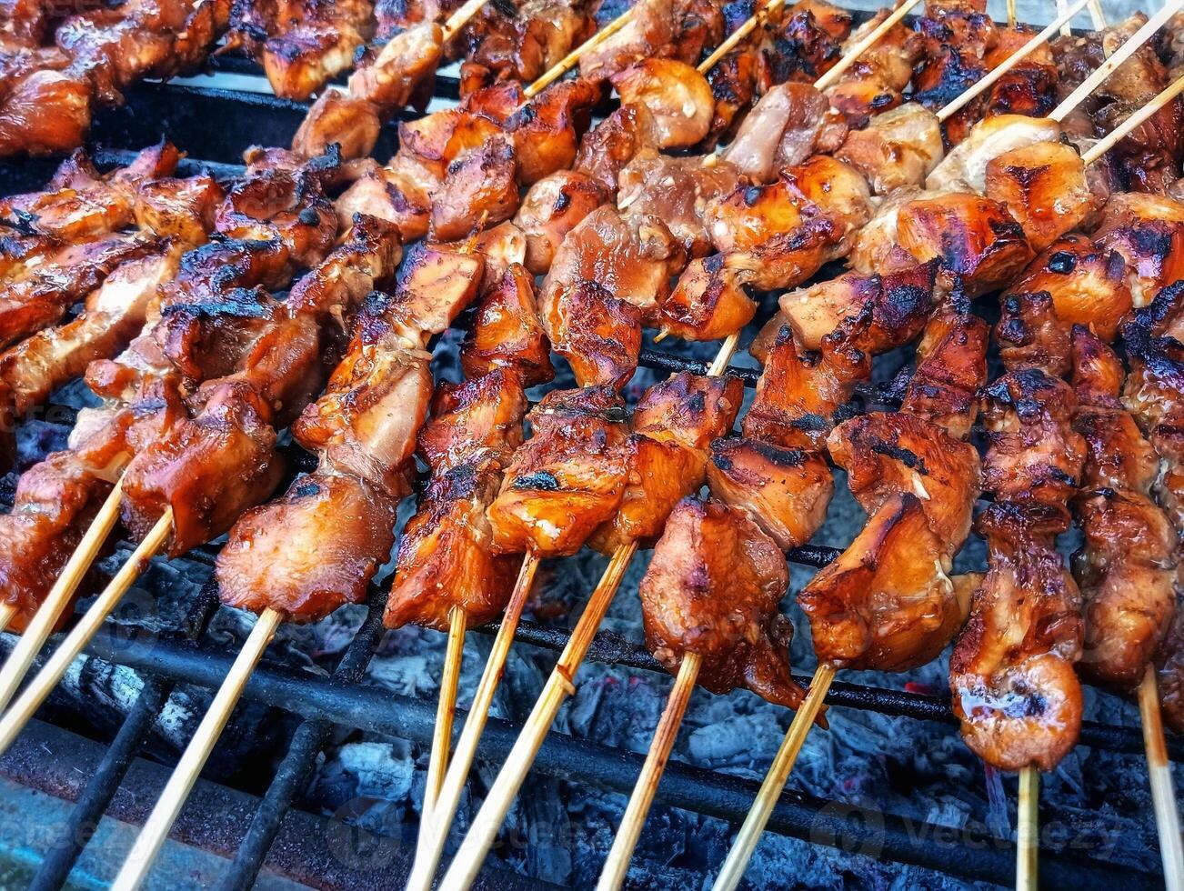 A grill with skewers of meat on it photo