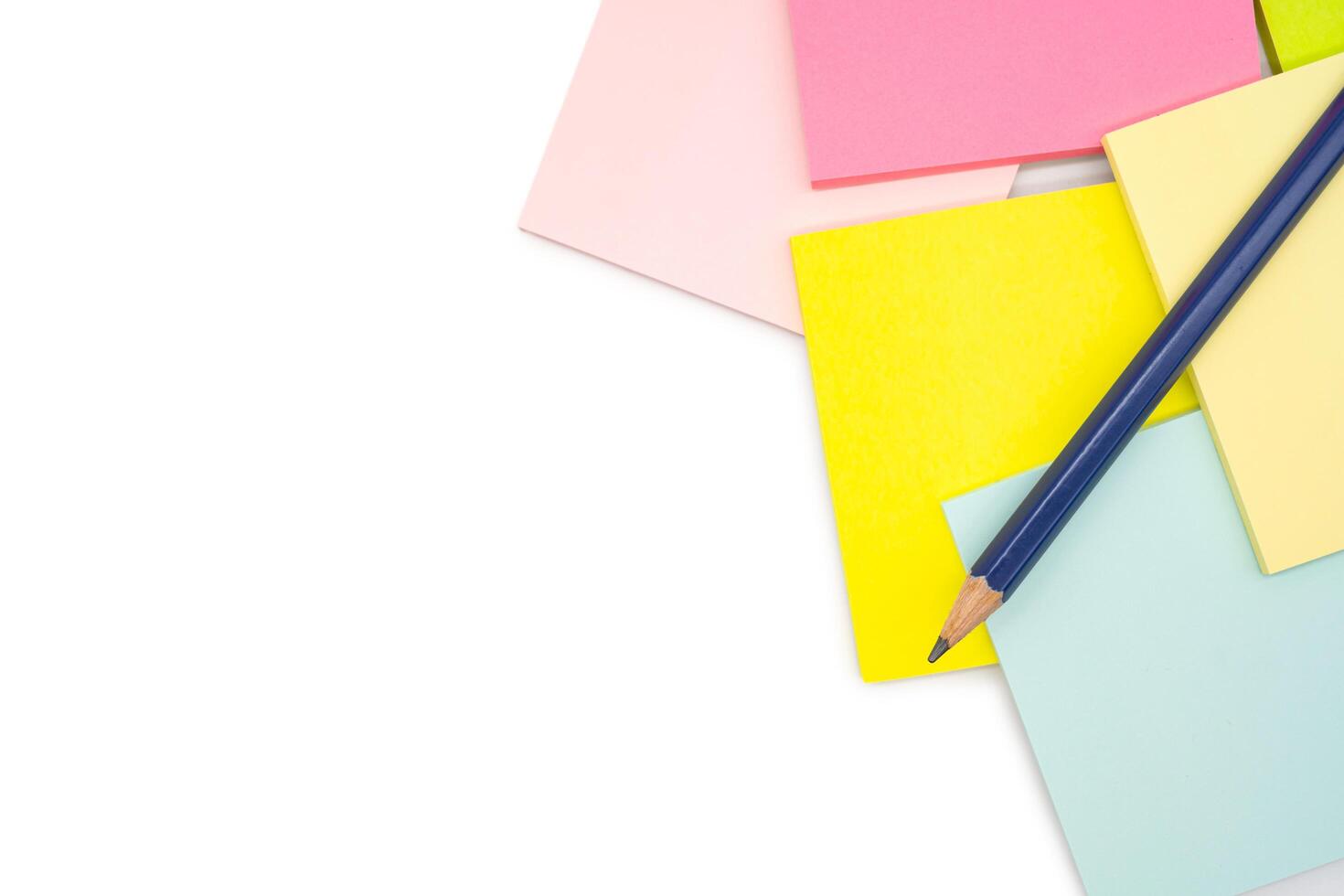 Pencil on blank colorful sticky note isolated on white background. Copy space. photo