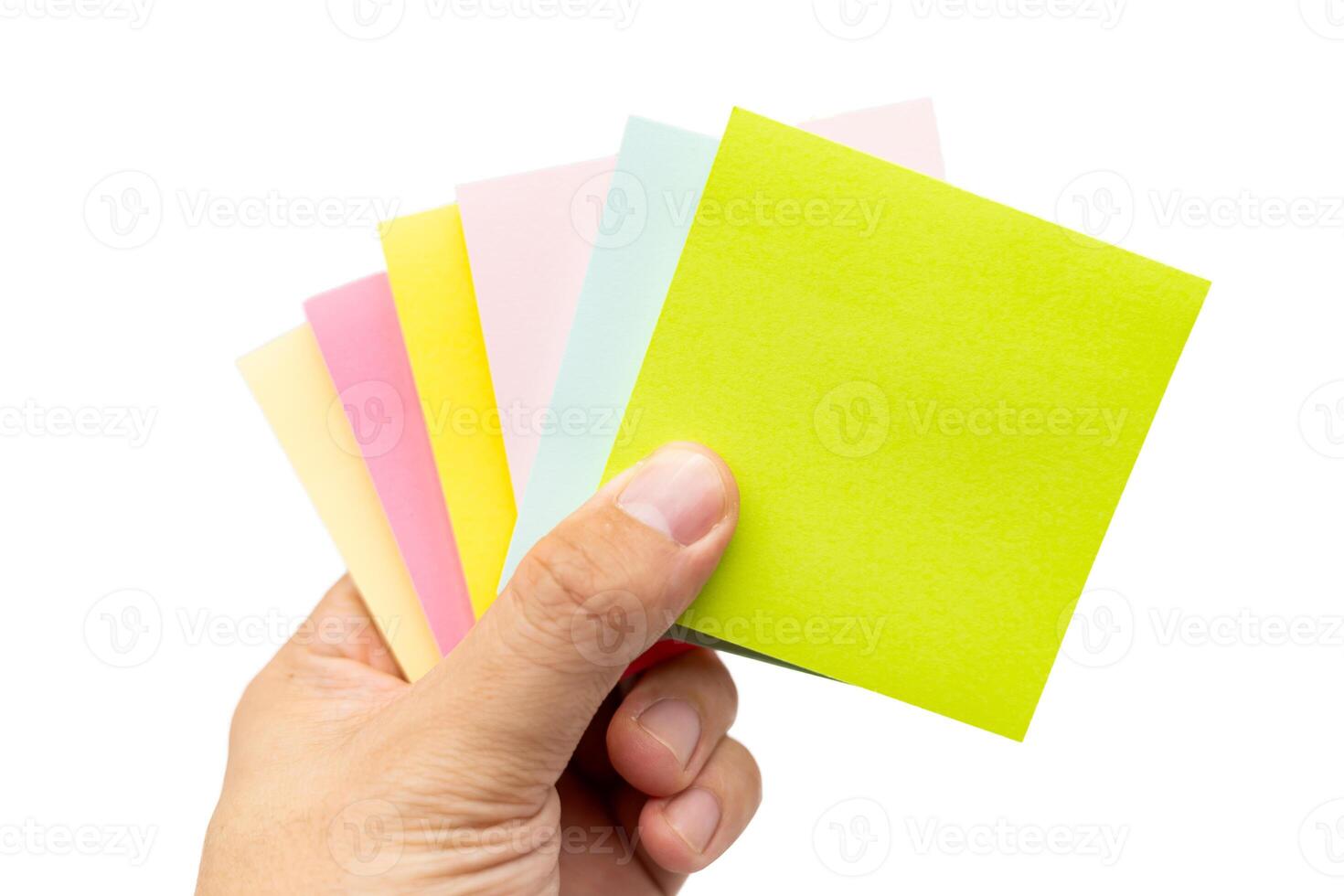 Hand holding blank colorful sticky note isolated on white background. Copy space photo