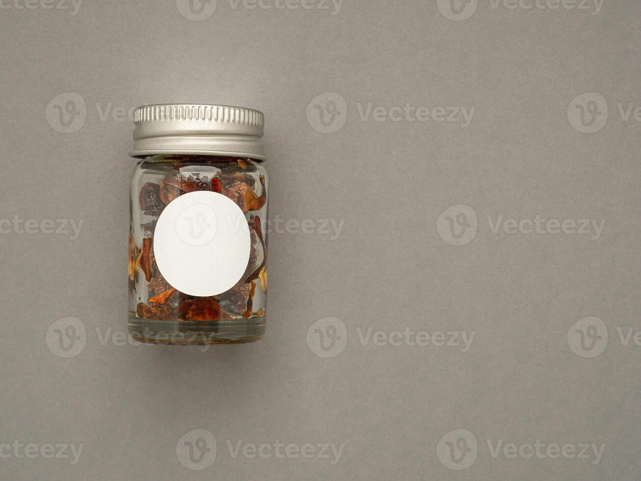 Top view of a bottle container herbal over a gray background. Blank label for branding mockup photo
