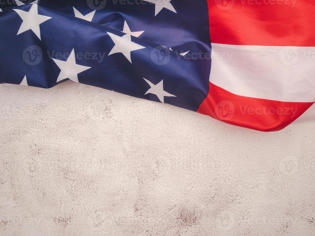 Top view of the American flag on a cement floor with copy space for text. photo