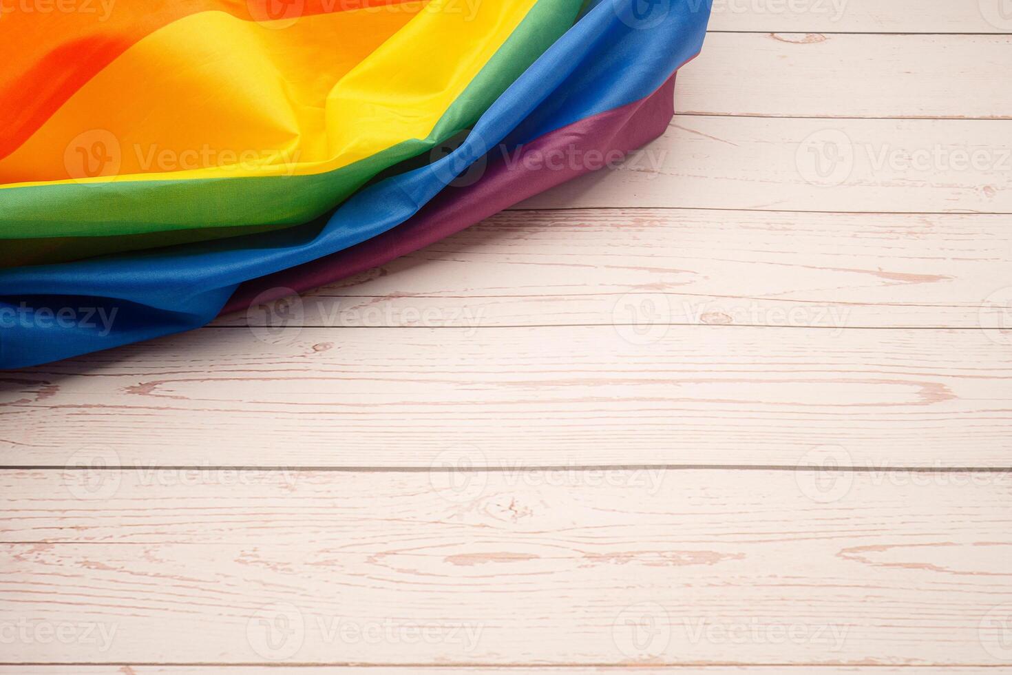 The rainbow flag or LGBT flag on a wooden table with copy space. photo