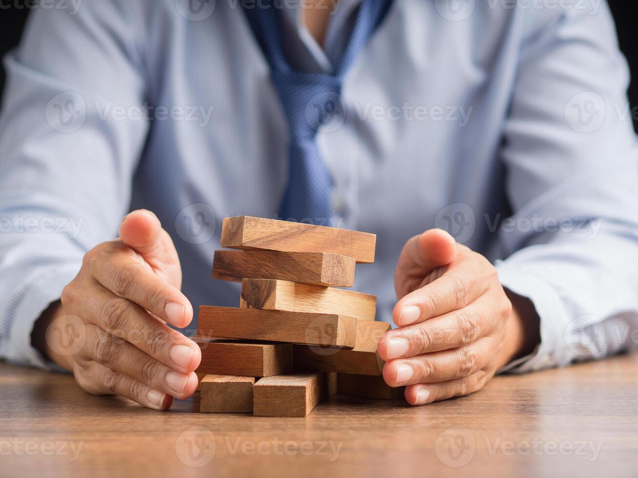 Hands businessman protect business crisis effect before the business collapse photo