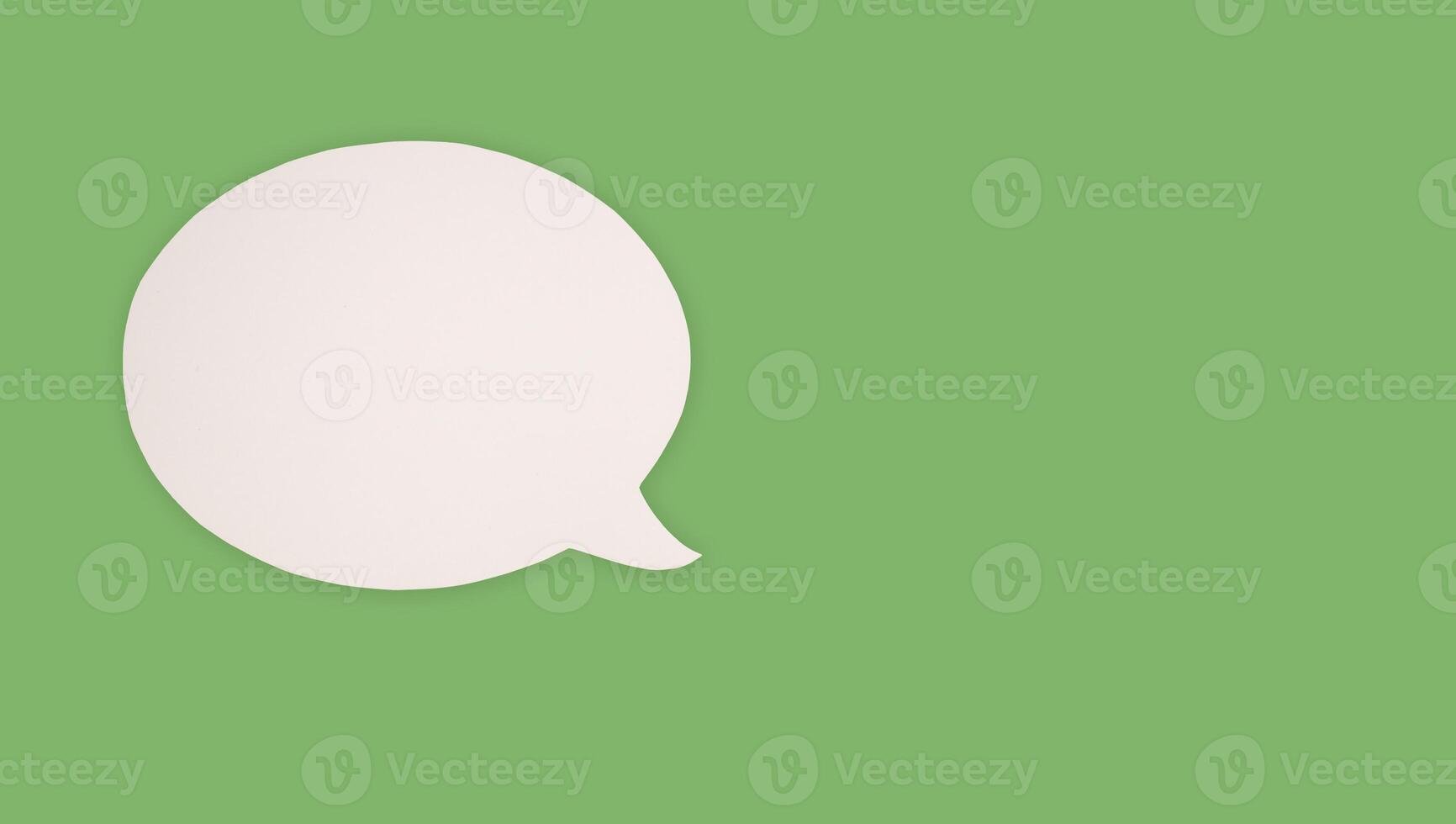 Blank white speech bubble part on a green background photo