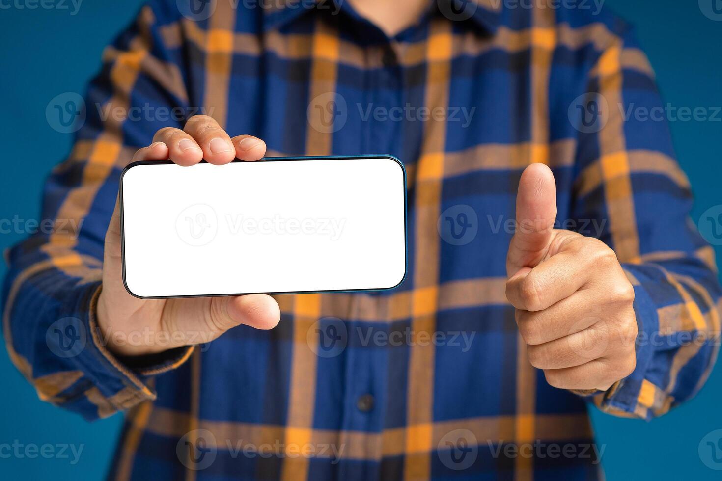 Close-up of hand holding a smartphone and thumbs up photo