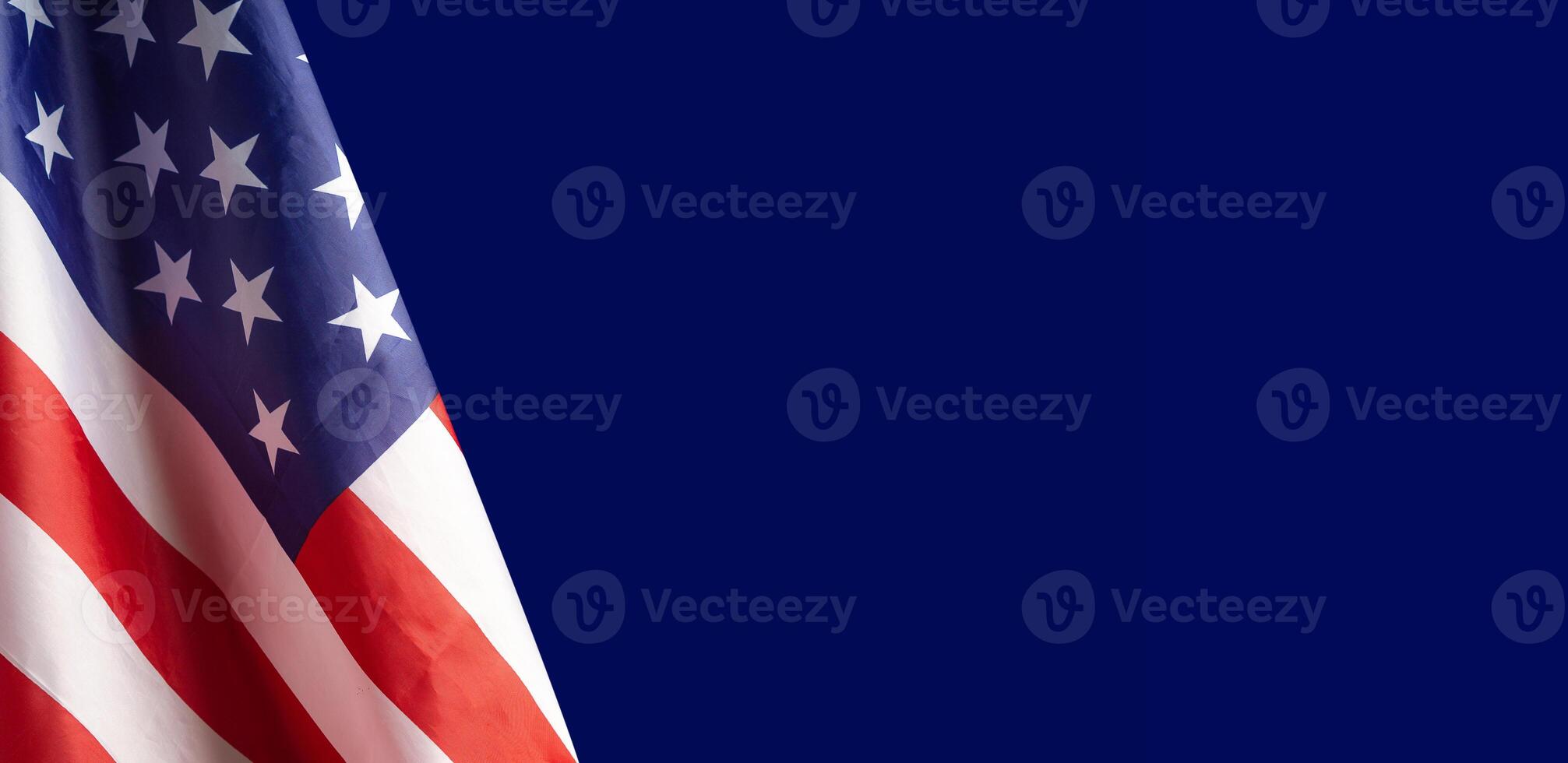 Close-up of the American flag is on the left side on a blue background photo
