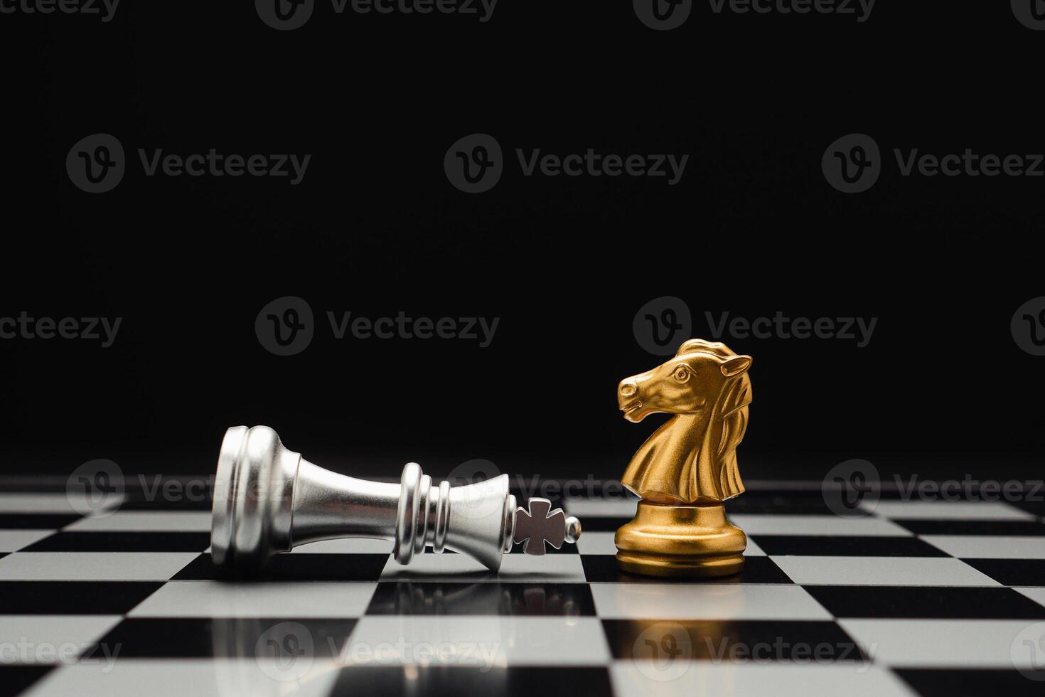 Chess pieces on board game planning and competition on black background photo