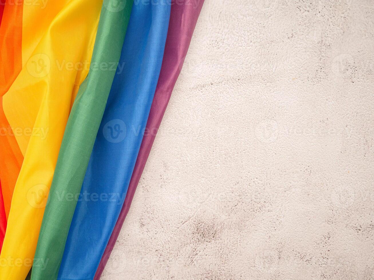 Top view of the rainbow flag or LGBT is on a cement floor with copy space photo