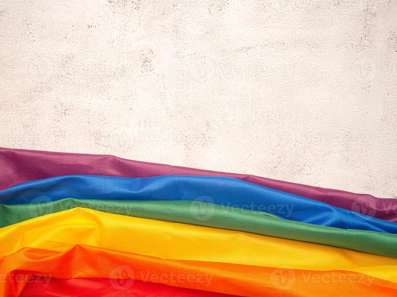 Top view of the rainbow flag or LGBT is on a cement floor with copy space photo