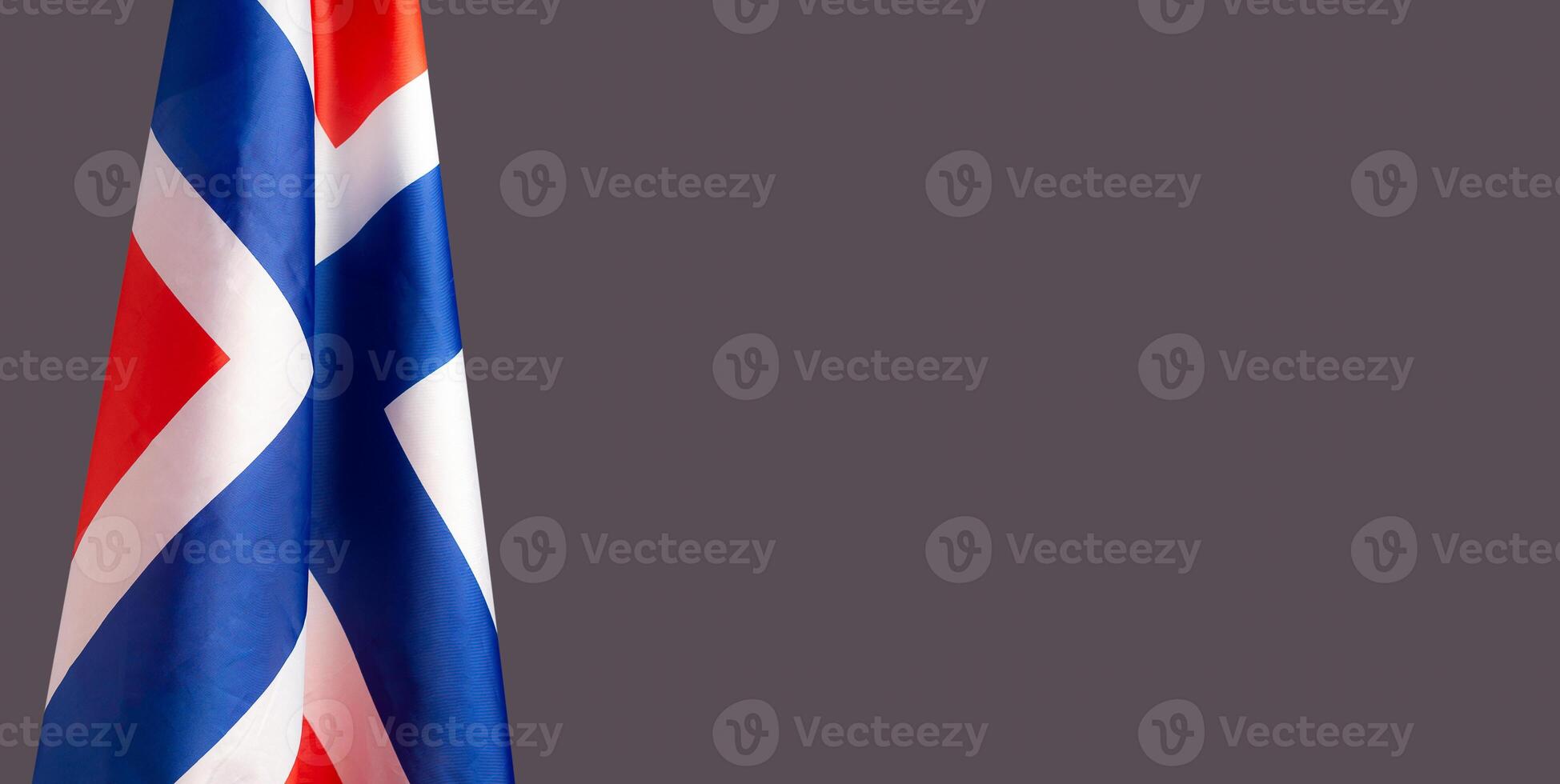 Close-up of the Norway flag is on the left side on a gray background photo