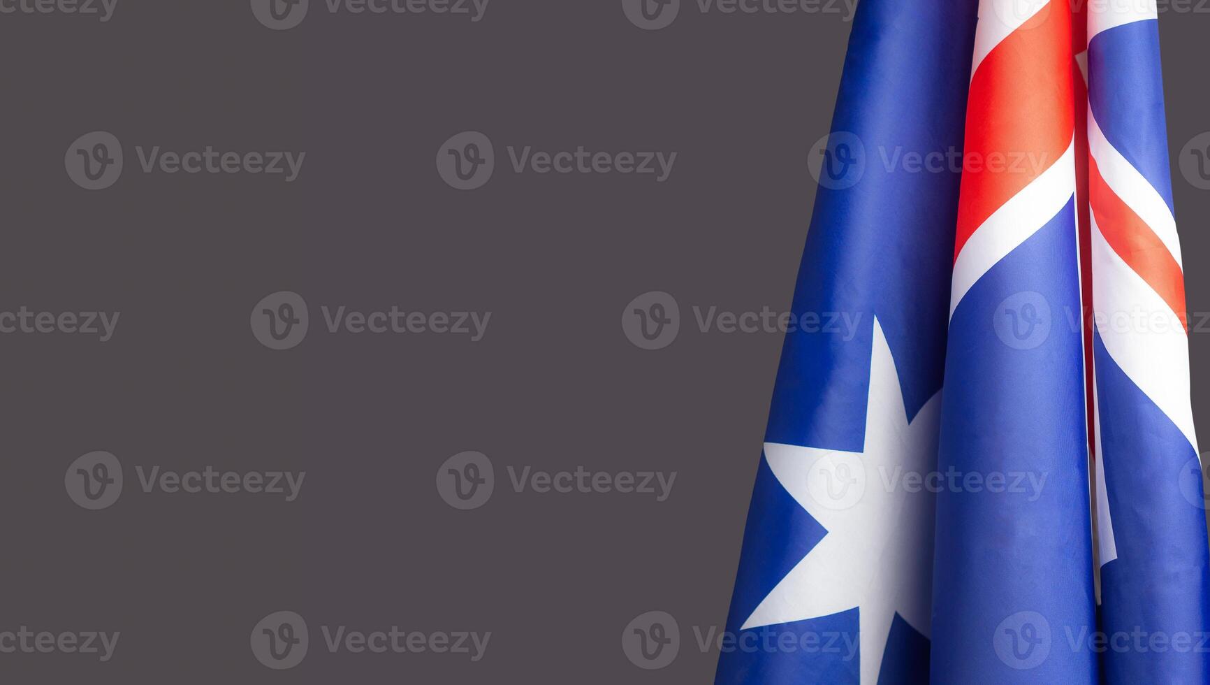Close-up of the Australian flag is on the right side on a gray background photo