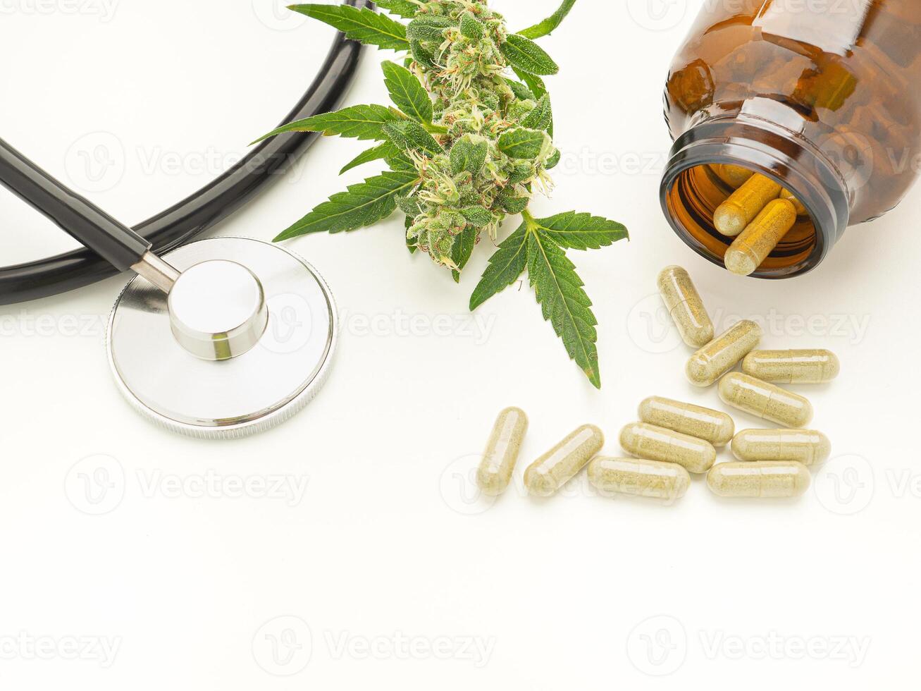 A stethoscope, cannabis buds flower, and pills are out of bottle isolated on a white background photo