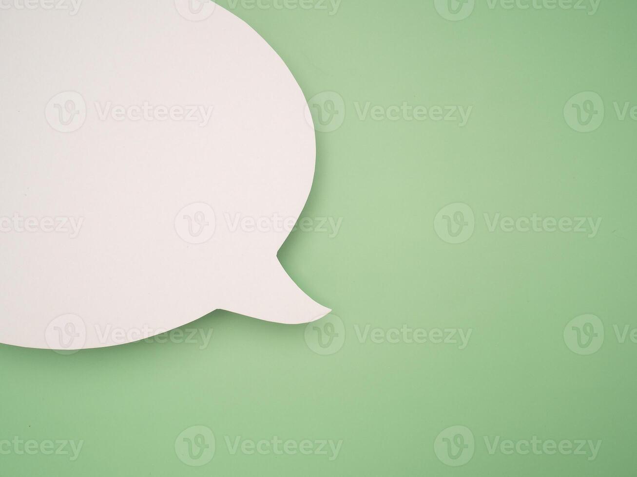 Blank white speech bubble part over a green background photo