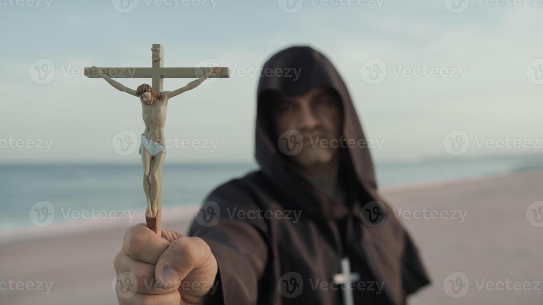 Monk With Statuette Of Jesus In His Hand Prays photo